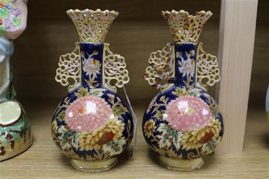 A pair of Zsolnay Pecs reticulated vases, floral-decorated on a blue ground and heightened in gilt height 20cm (a.f.)